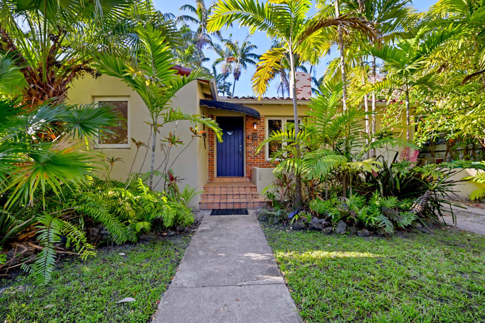 Front walkway approach in Belle Meade with tropical landscaping and garden path