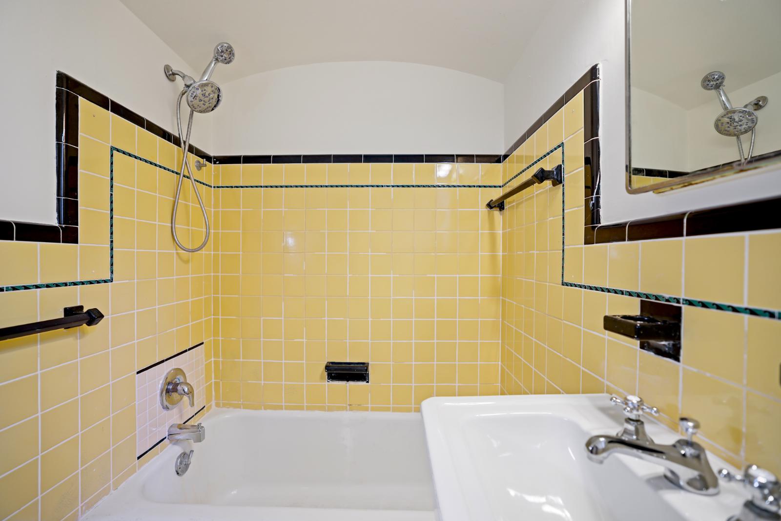 Full bathroom with vintage yellow tile surround